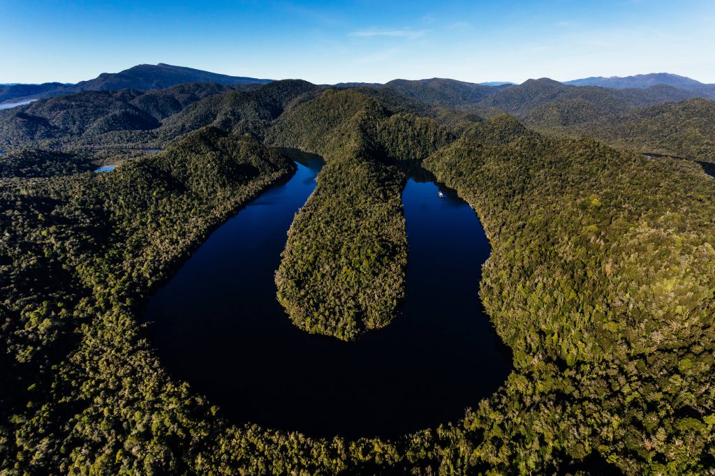 A magnificent u-bend of the gordon river, deep in the UNESCO world heritage wilderness site. The land that surrounds the river is thick with rainforest.